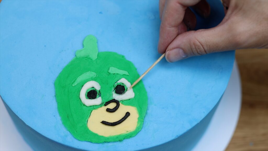 touching up buttercream with a toothpick