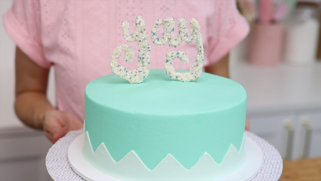 buttercream zig zag cake with sprinkle chocolate cake topper