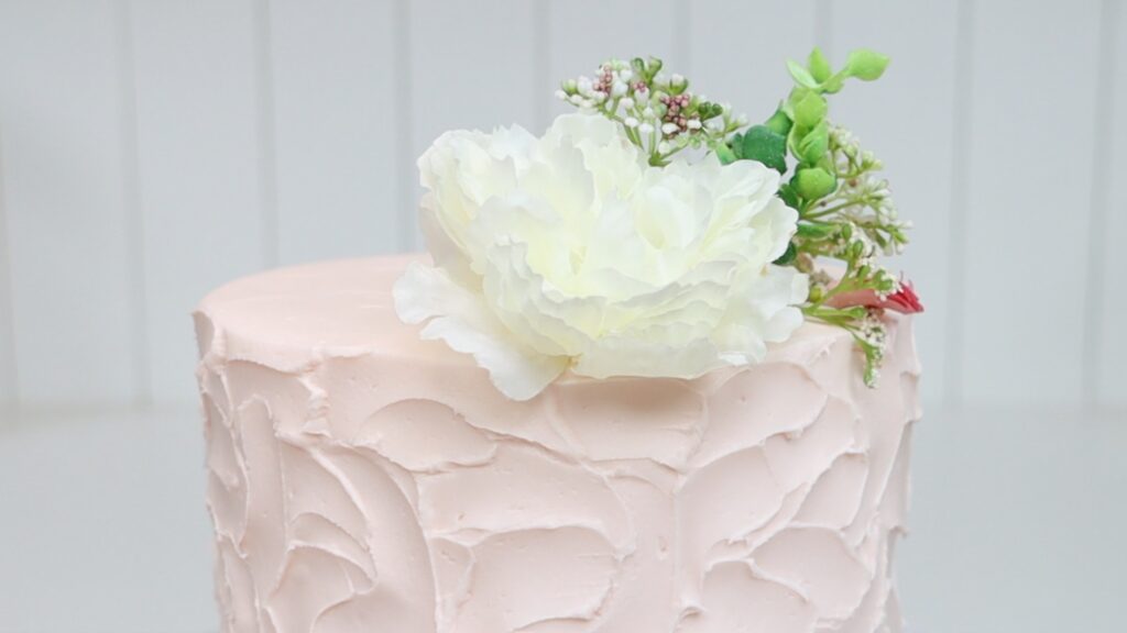 cake decorated with artificial flowers