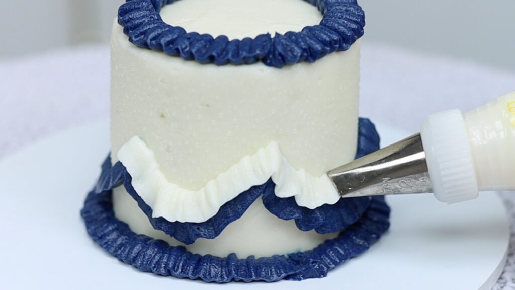 piping a vintage cake with cookie cutter pattern