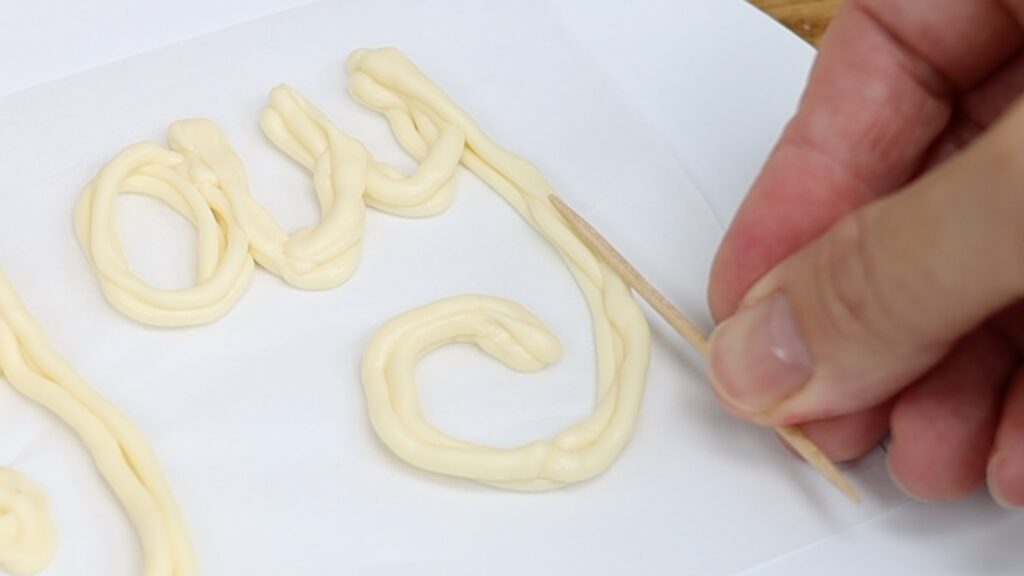 use toothpicks to attach cake toppers to a cake