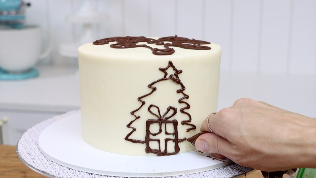 drawing with chocolate on the side of a cake