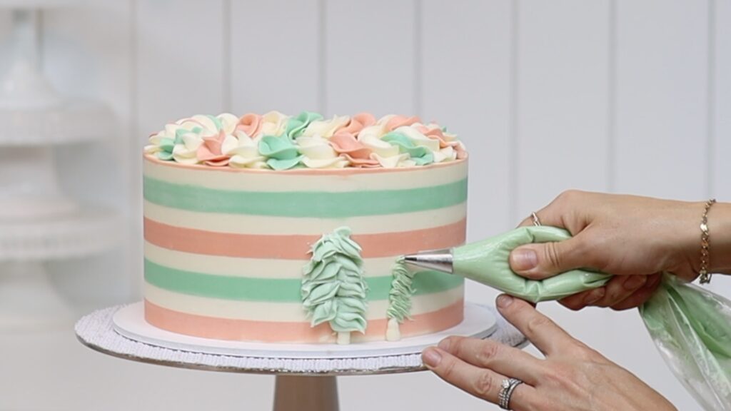 how to pipe buttercream christmas trees onto a cake