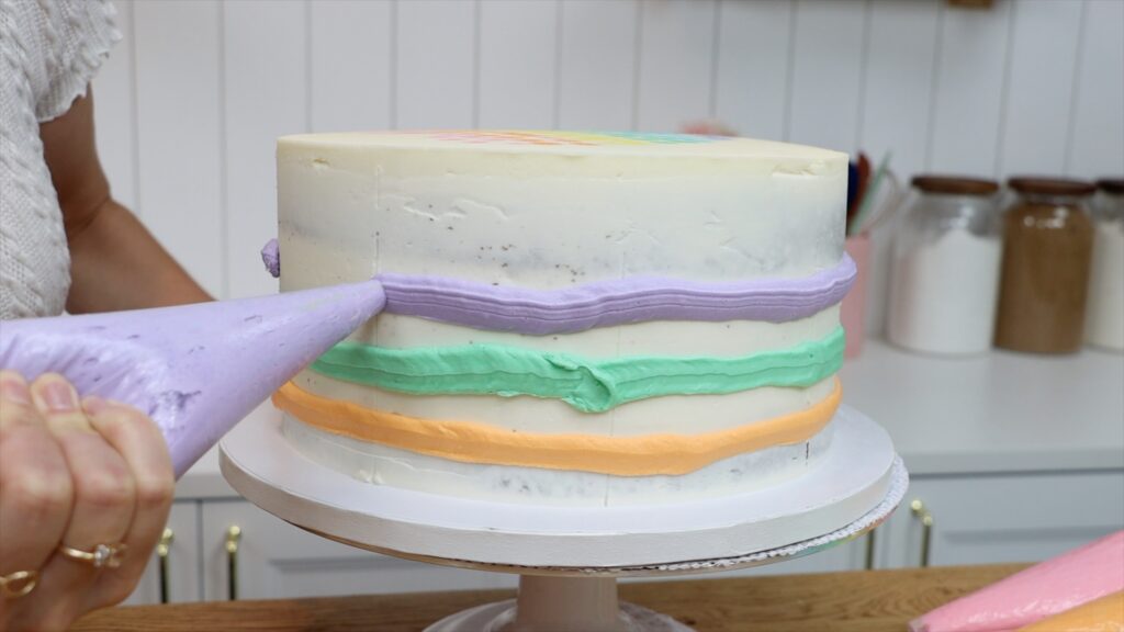 how to use a striped cake comb for multicolored stripes on a buttercream cake