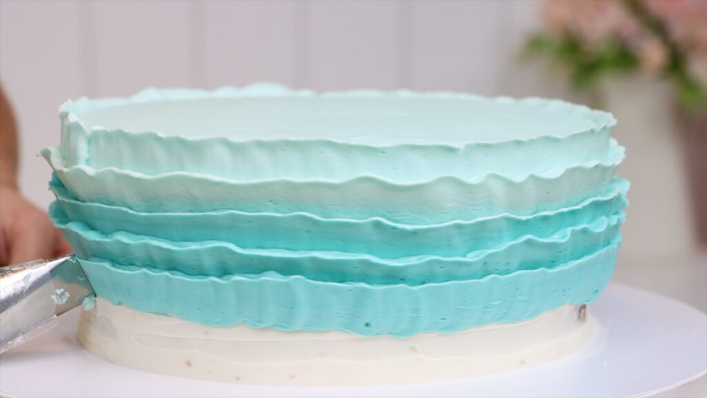 piping frosting onto a cake