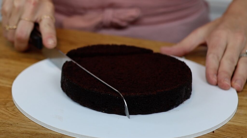 cut two sides off a round cake to make a heart cake