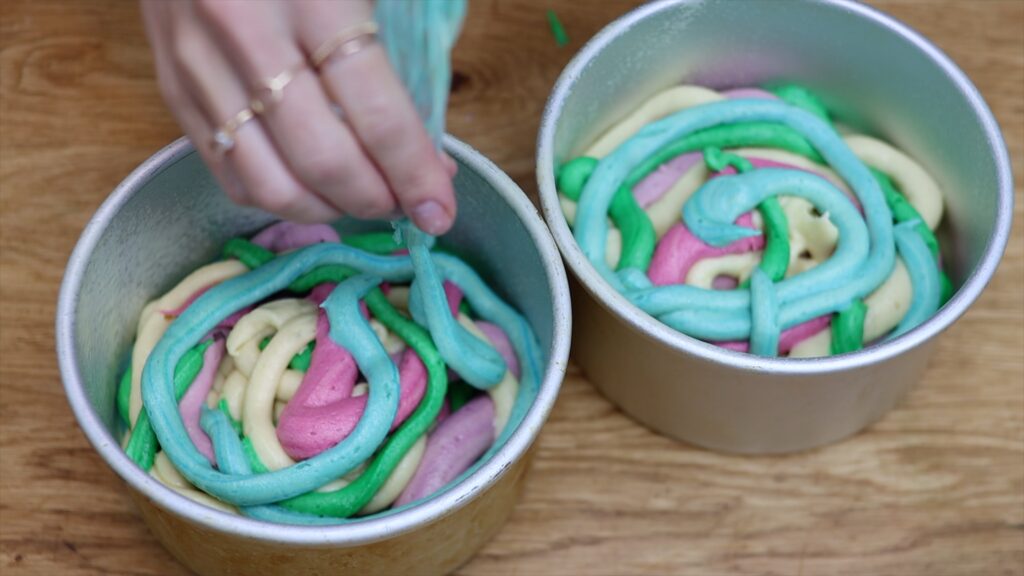 pipe rainbow batter into cake pans