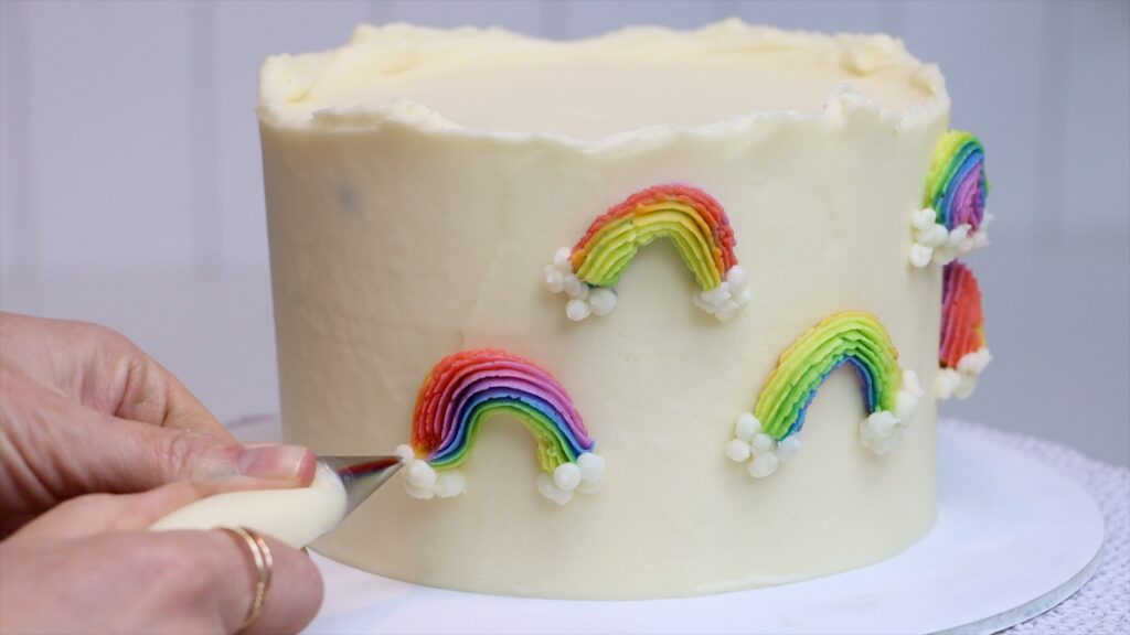 piping a rainbow cake