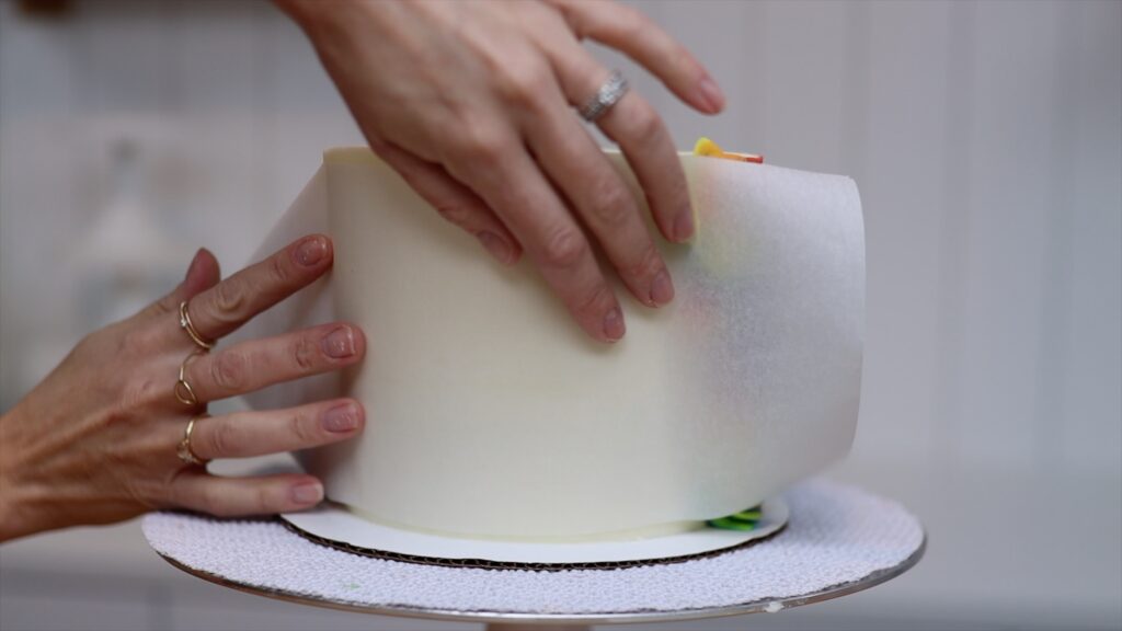 wrap parchment around the cake to make a grid template