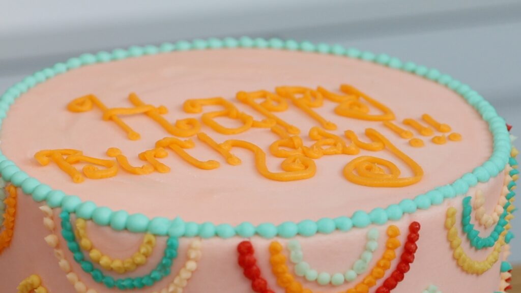 writing a message on cake with piping bags