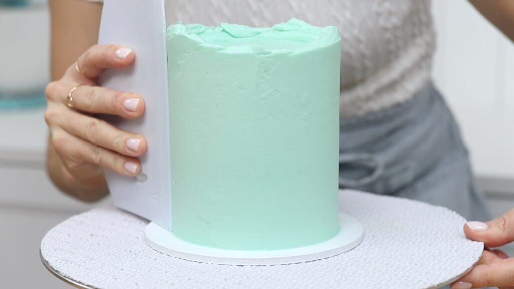 Cake struggles with leaning cakes can be fixed by adding more frosting and scraping again