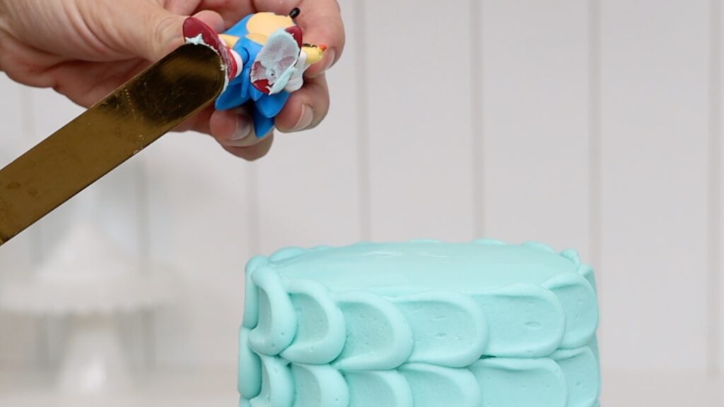 how to attach toy figures to a cake