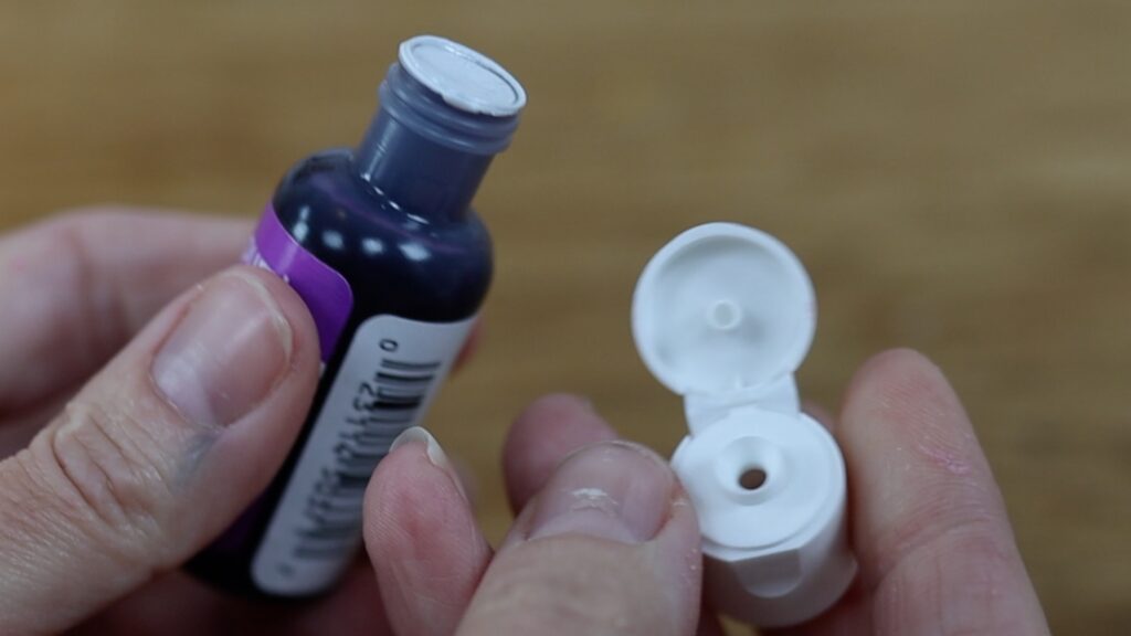 open gel colors by pushing the spike on the lid through the lining so they don't leak