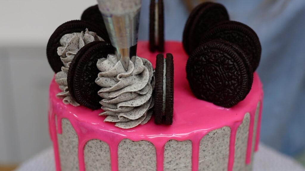 oreo cookie cake toppers with frosting swirls in between