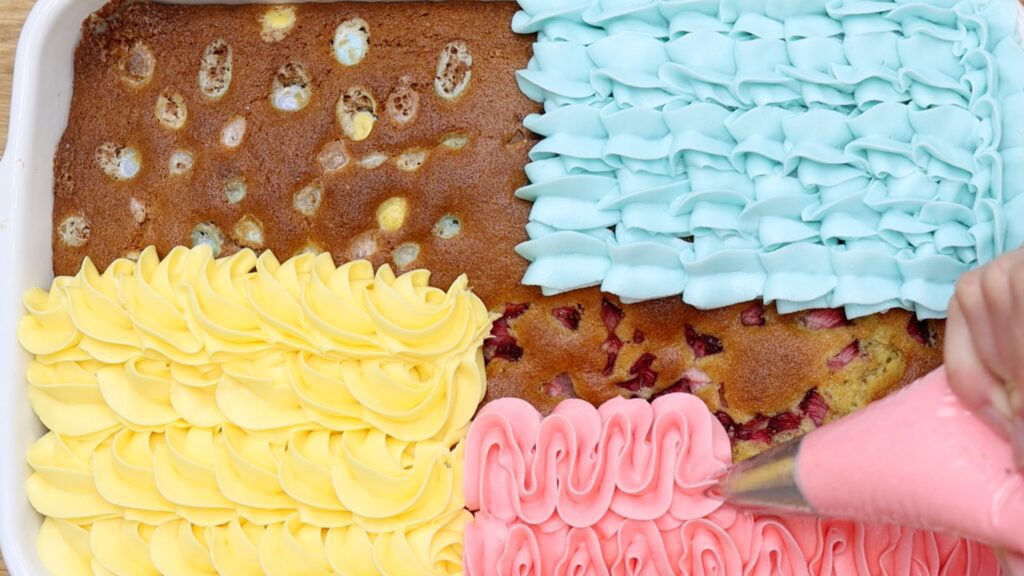 piping frosting onto a tray bake cake for easter cake ideas