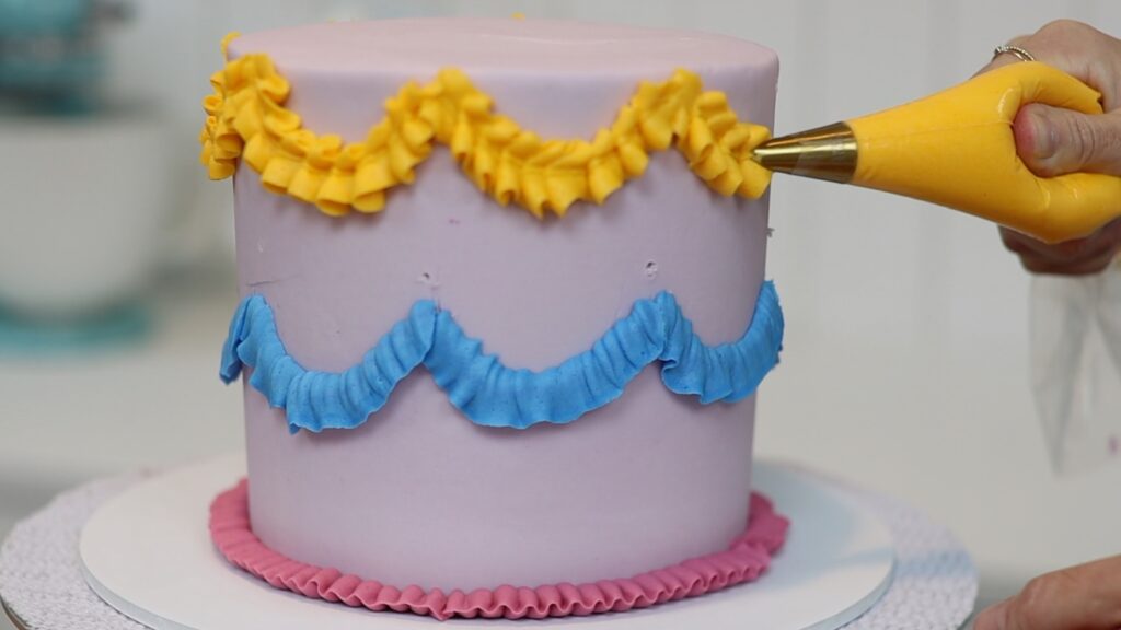 piping ruffles and swags with a leaf tip on vintage cakes