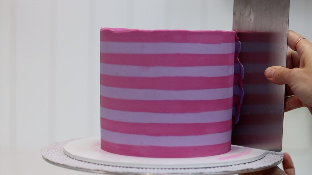 use a hot metal cake comb for smooth frosting on striped cakes