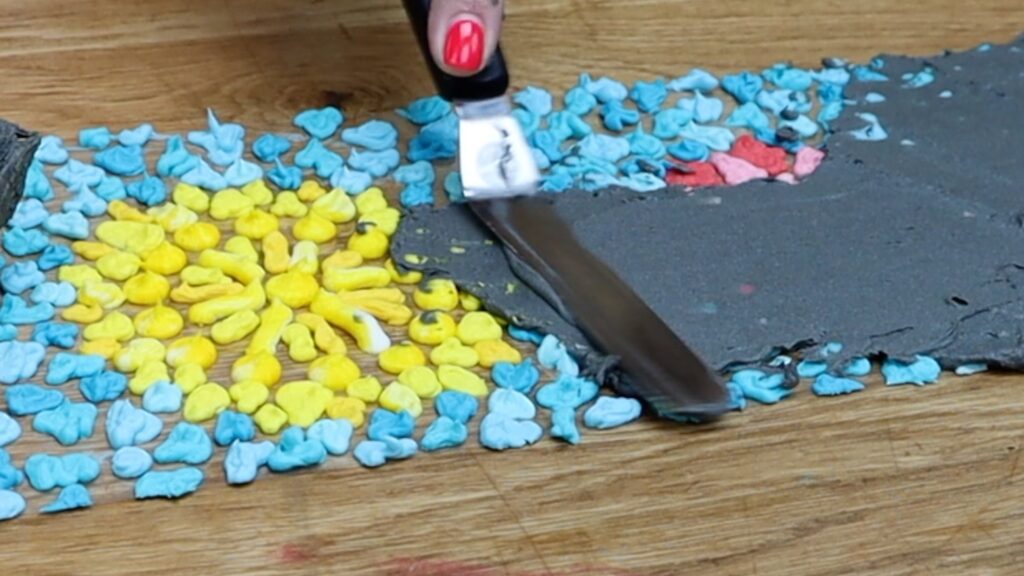 spread buttercream over entire acetate moasic cake design