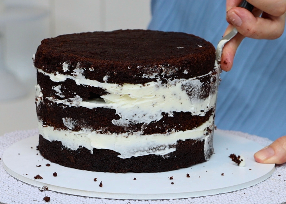 Chilled, assembled cake on a turntable ready to be frosted