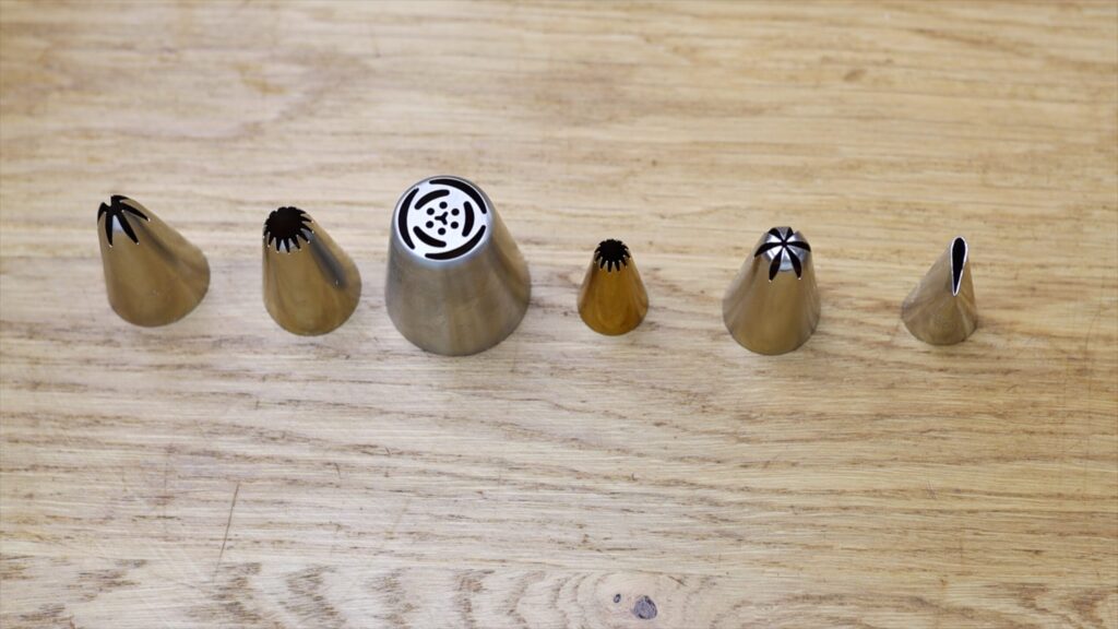 piping tips used for decorating colourful texture on a stand up rainbow cake