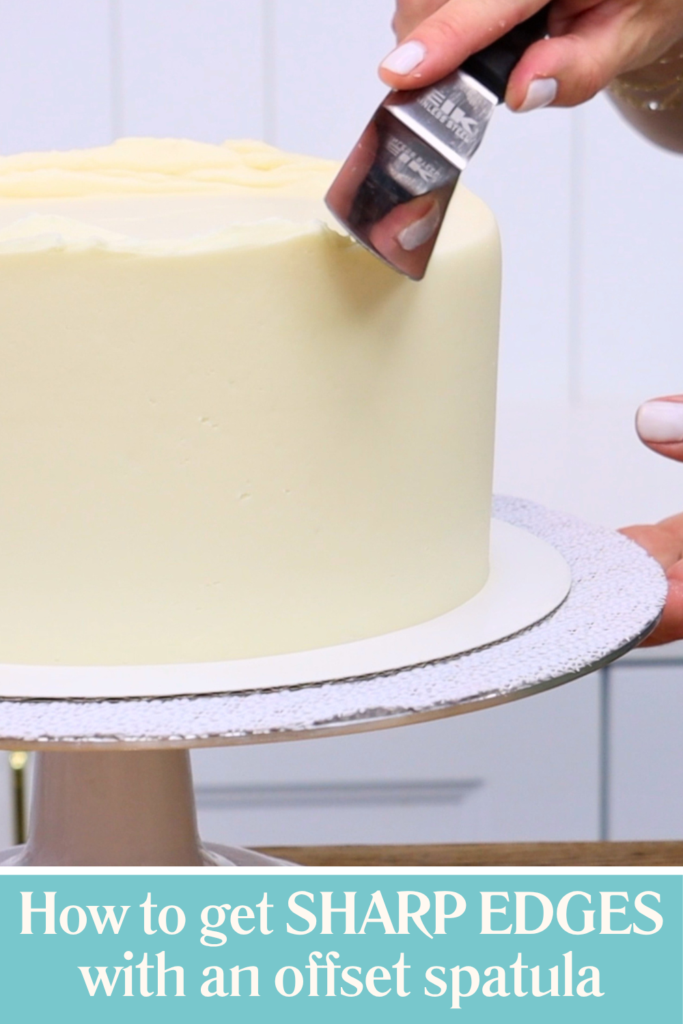 Using an offset spatula to smooth buttercream inward and create sharp edges on a cake