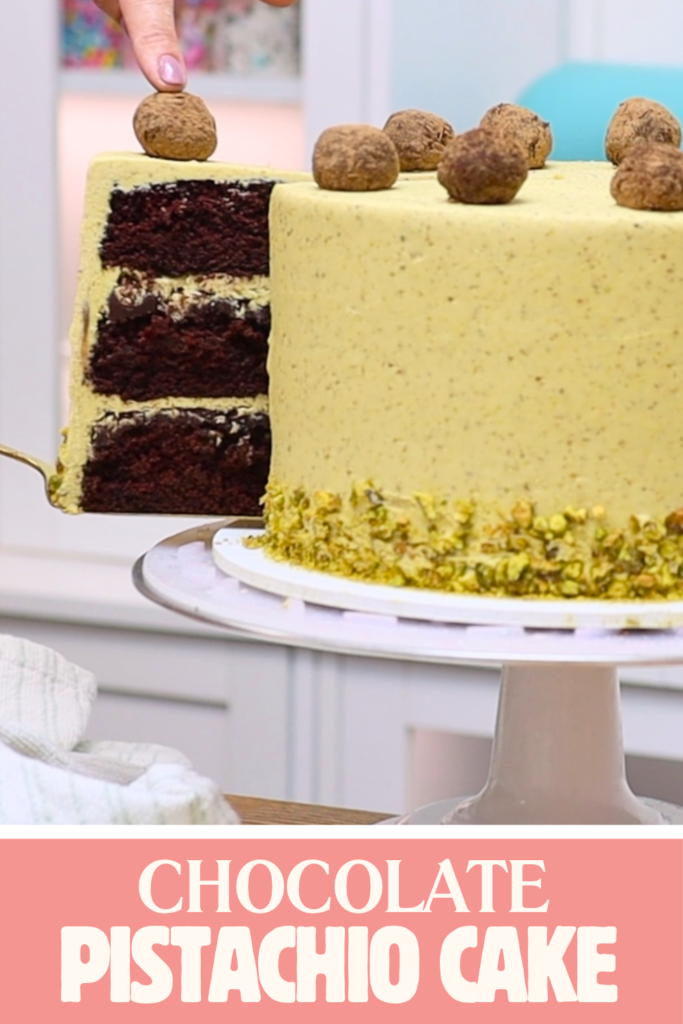 Chocolate pistachio cake with a slice removed to reveal chocolate cake layers and pale green pistachio buttercream